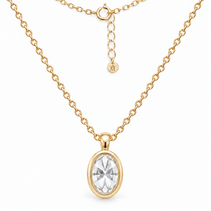 Reverse view of the 14K gold bezel pendant and bail. AI-edited crown-M engraving concept on the existing extender end disc; engraving and scale are illustrative.