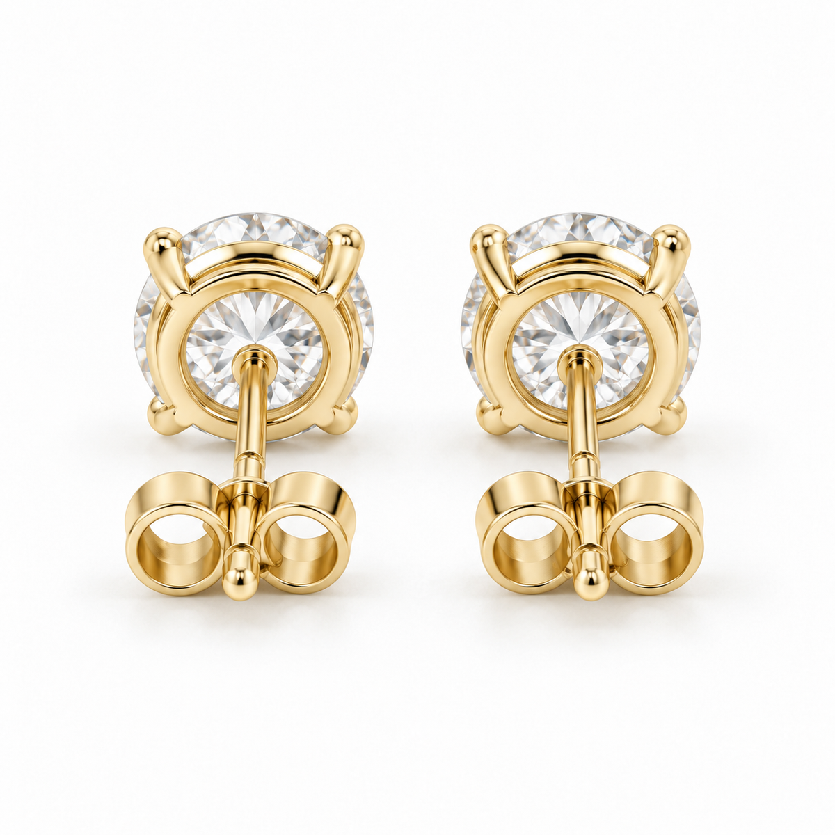 Back view of matched 14K gold diamond stud earrings and push-back closures.