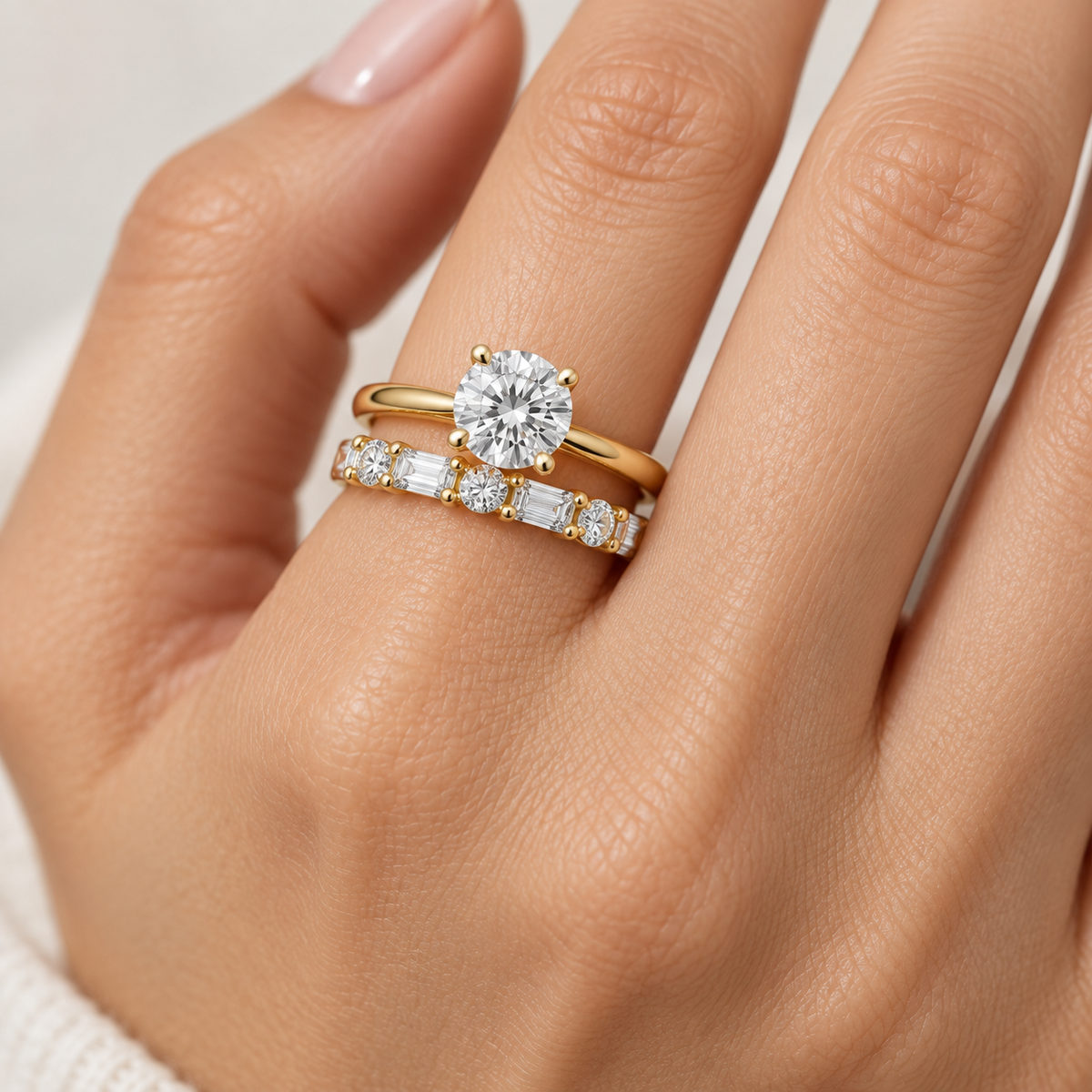 Half-eternity diamond band worn on a hand beside a simple engagement ring.