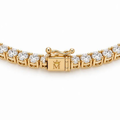 Close view of the tennis necklace box clasp and double safety latches. AI-edited crown-M engraving concept on the existing clasp face; engraving and scale are illustrative.