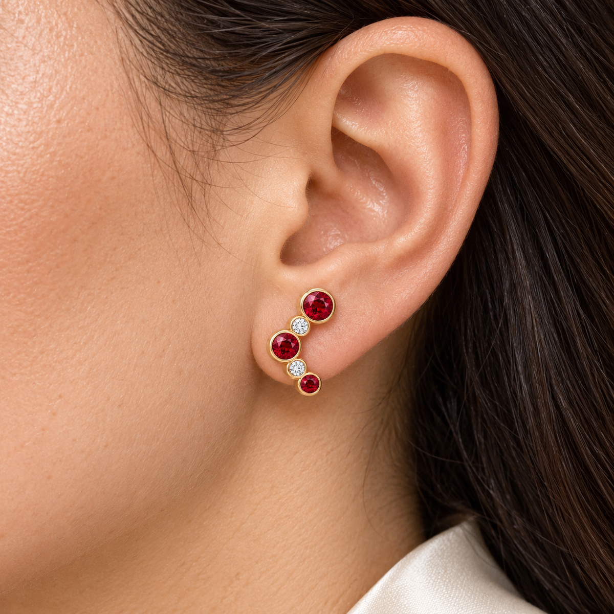 MISSISSI Scarlet Arc Graduated Lab-Grown Ruby & Diamond Studs in yellow gold, worn design visualization