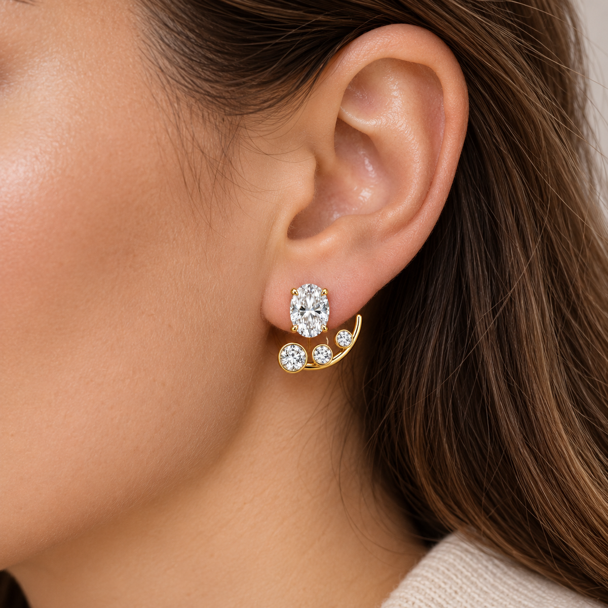 Arclet on-ear visualization with one oval stud and three round jacket diamonds, illustrative scale