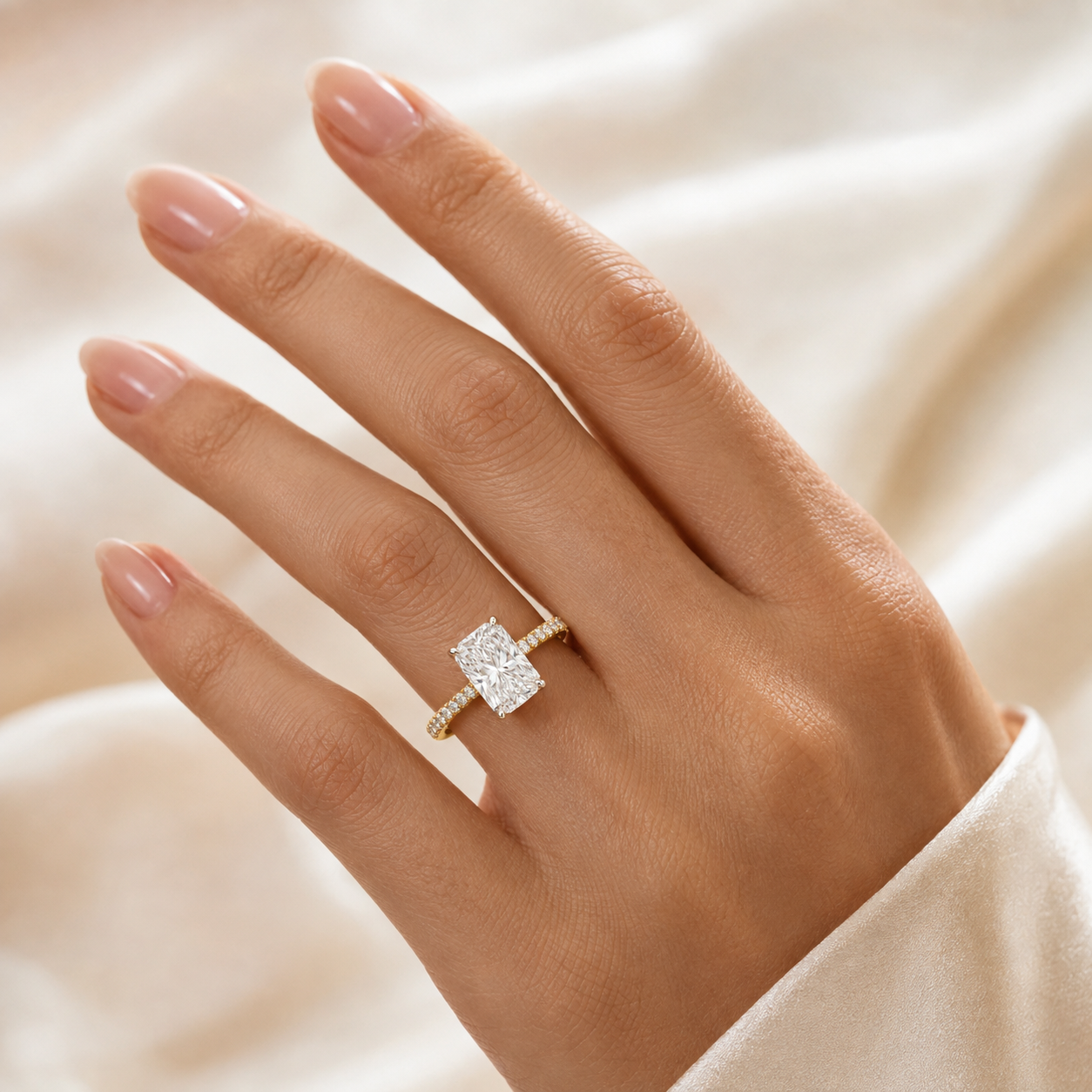 Macro detail of platinum claws, hidden halo and pavé diamonds on elongated radiant ring