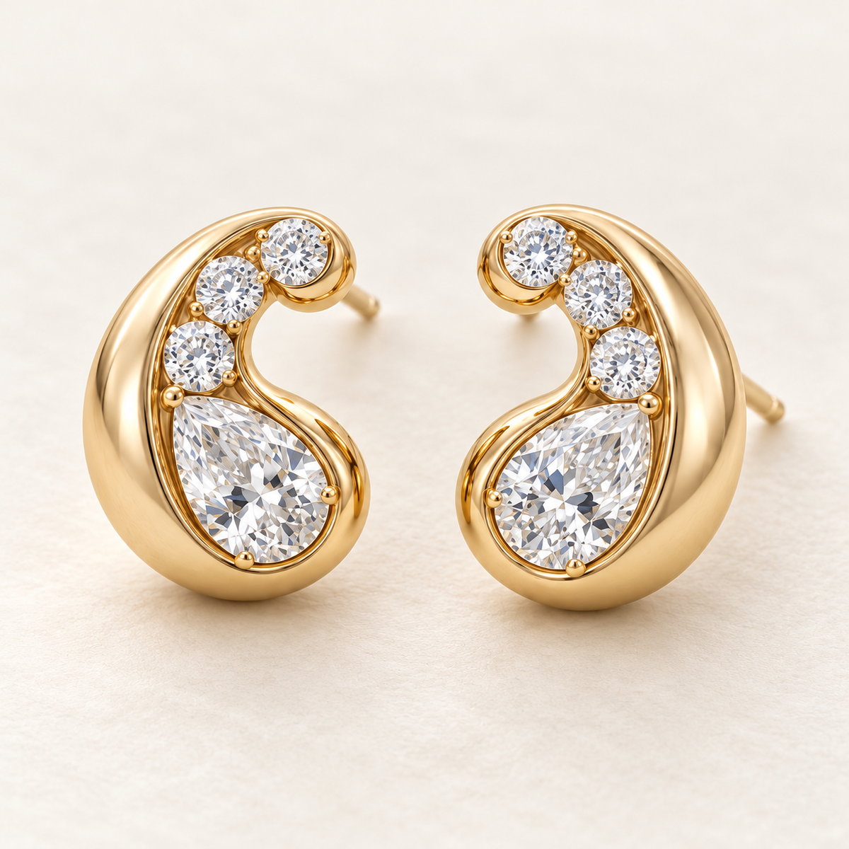 MISSISSI AA13 paired earrings in yellow gold tone, three quarter view showing mirrored rounded comma-shaped curls around pear-shaped diamonds, with three round diamond accents per earring; design visualization