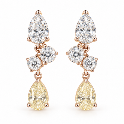 MISSISSI AA20 paired earrings in pale rose gold tone, front view showing a white pear-shaped diamond above two diagonally arranged round diamonds and a pale-yellow pear-shaped drop; design visualization
