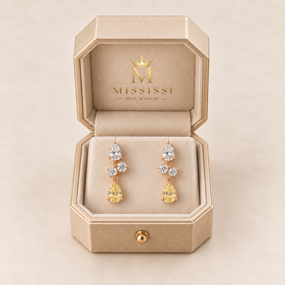 MISSISSI Yellow Lightfall pear lab-grown diamond drop earrings in rose gold, presented as a pair in champagne octagonal packaging with crown M branding; design visualization.