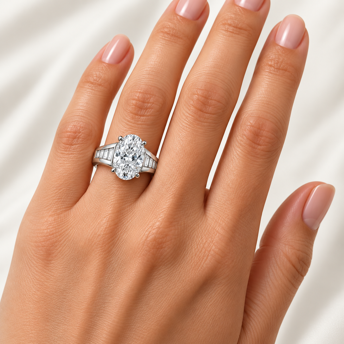 Oval Cadence white-metal ring worn on one finger; design visualization with illustrative scale
