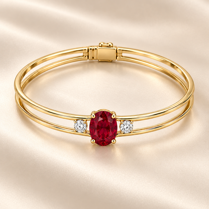 MISSISSI H26-RB01 yellow gold double-rail bangle with an oval lab-grown ruby and two round lab-grown diamonds. Complementary angle on champagne background.; design visualization