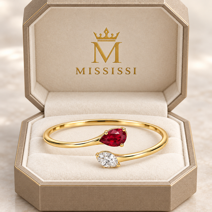 MISSISSI H26-RB03 yellow gold bypass bangle with red lab-grown ruby and white lab-grown diamond tips. Champagne octagonal MISSISSI packaging visualization.; design visualization