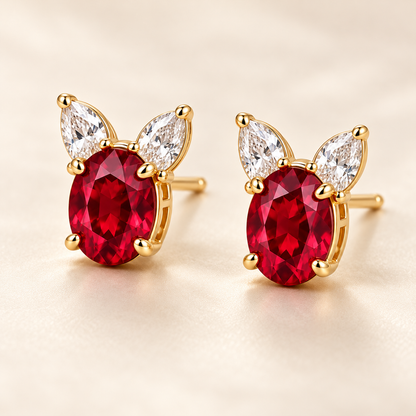 Three-quarter view of MISSISSI RE01 ruby and pear-shaped diamond stud earrings in yellow gold; design visualization