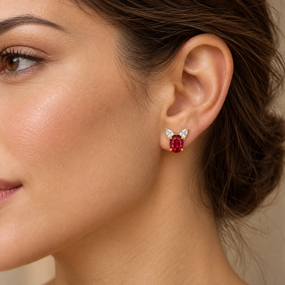 Adult model wearing one RE01 ruby and pear-shaped diamond stud earring; design visualization