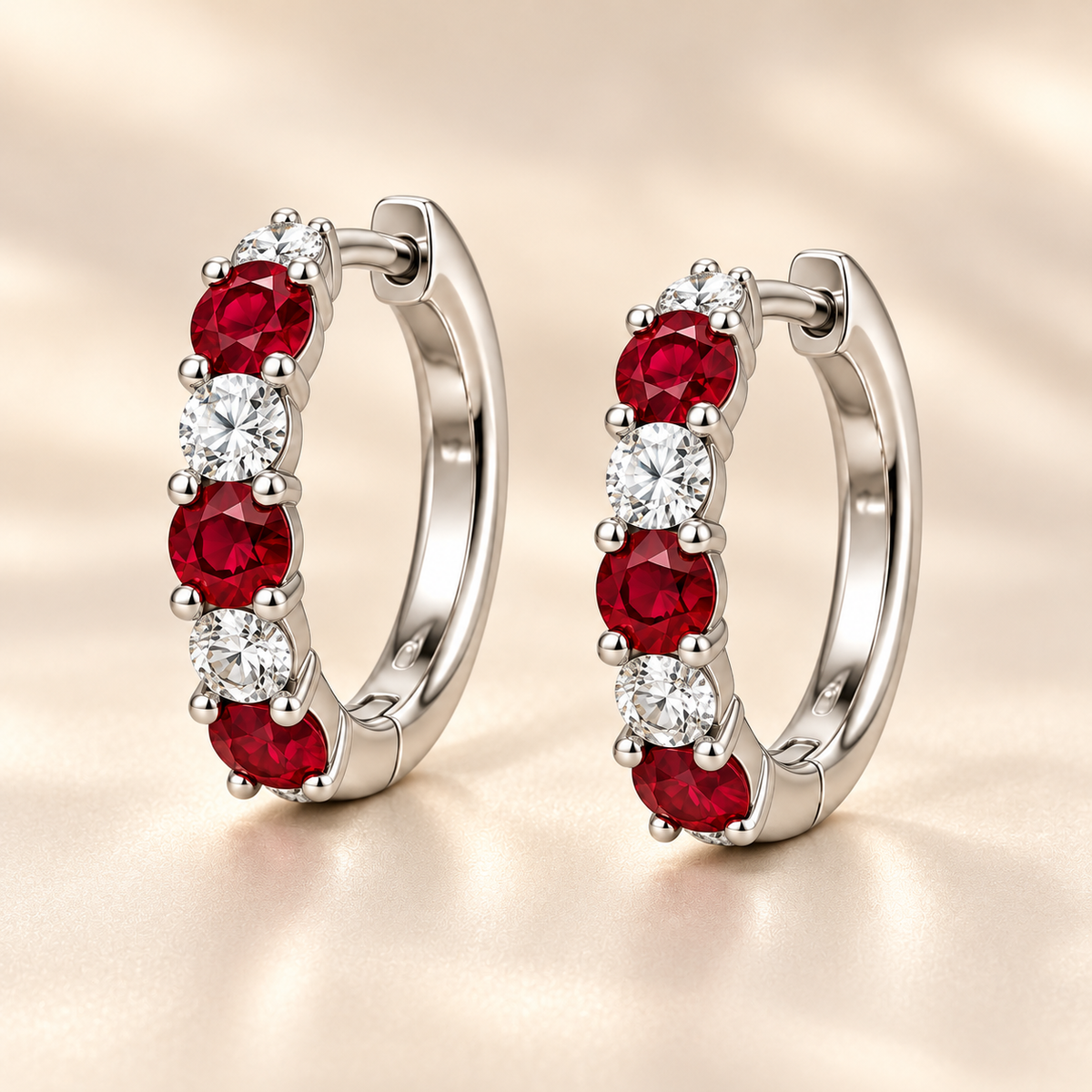 Three-quarter view of RE04 hoops with three round rubies and three round diamonds per earring; design visualization