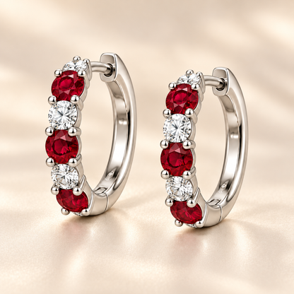 Three-quarter view of RE04 hoops with three round rubies and three round diamonds per earring; design visualization