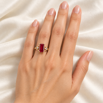 MISSISSI Crimson Ribbon lab-grown ruby ring in yellow gold with two baguette lab-grown diamond accents, left-hand wearing visualization.