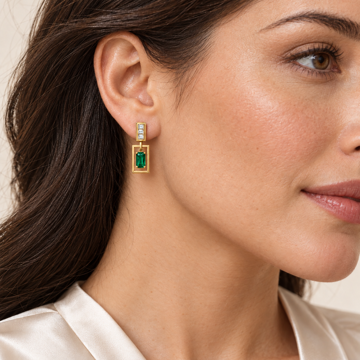 MISSISSI EM36 PORTAL emerald drop earrings, yellow gold model light skin scale corrected; design visualization