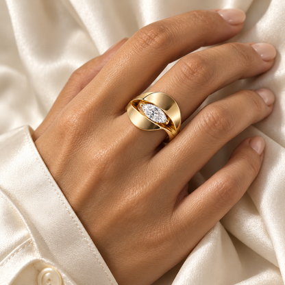 Eclipse yellow-gold marquise diamond ring shown on a hand against an ivory silk blouse, design visualization.