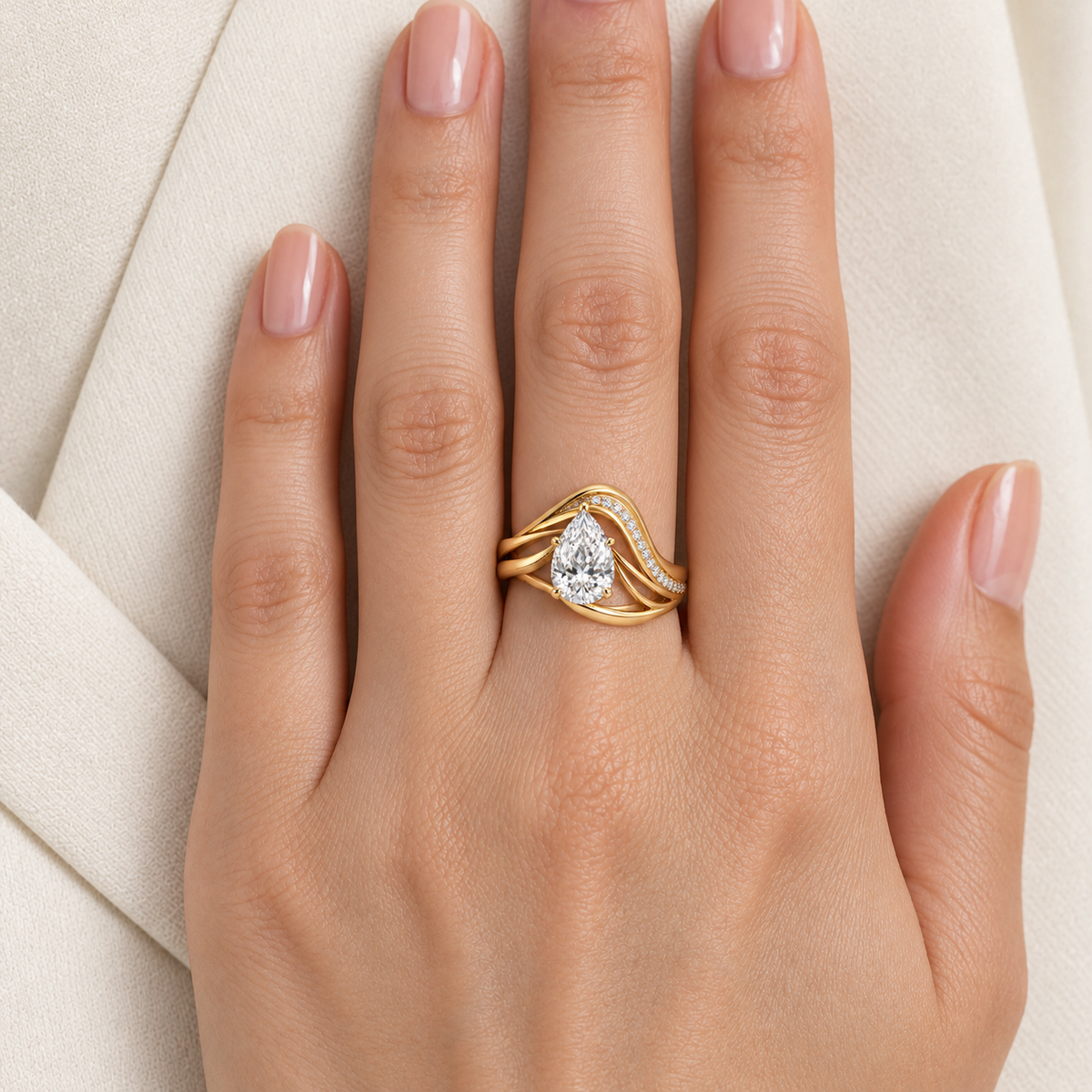 MISSISSI Aerial yellow gold pear lab-grown diamond arc ring worn snugly with pear aligned toward fingertip; design visualization