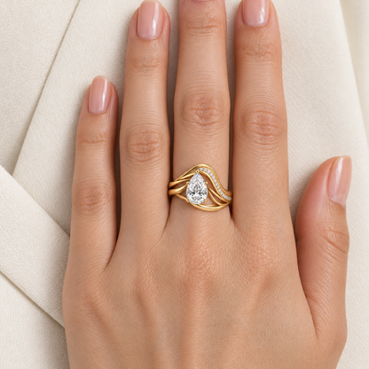 MISSISSI Aerial yellow gold pear lab-grown diamond arc ring worn snugly with pear aligned toward fingertip; design visualization