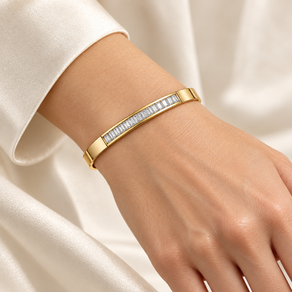 LINEA bangle worn close to a light-skinned adult wrist with ivory sleeve; design visualization