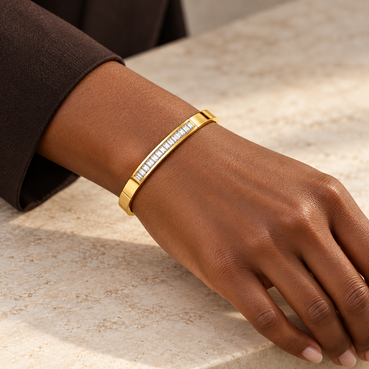 LINEA bangle worn close to a deep-brown-skinned adult wrist with dark sleeve; design visualization