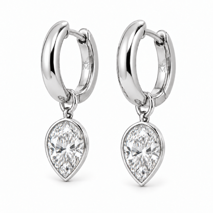 MISSISSI aurelle pear drop huggies in 14K white gold. AI-edited crown-M engraving concept on visible inner rear hoop surfaces; engraving and scale are illustrative.
