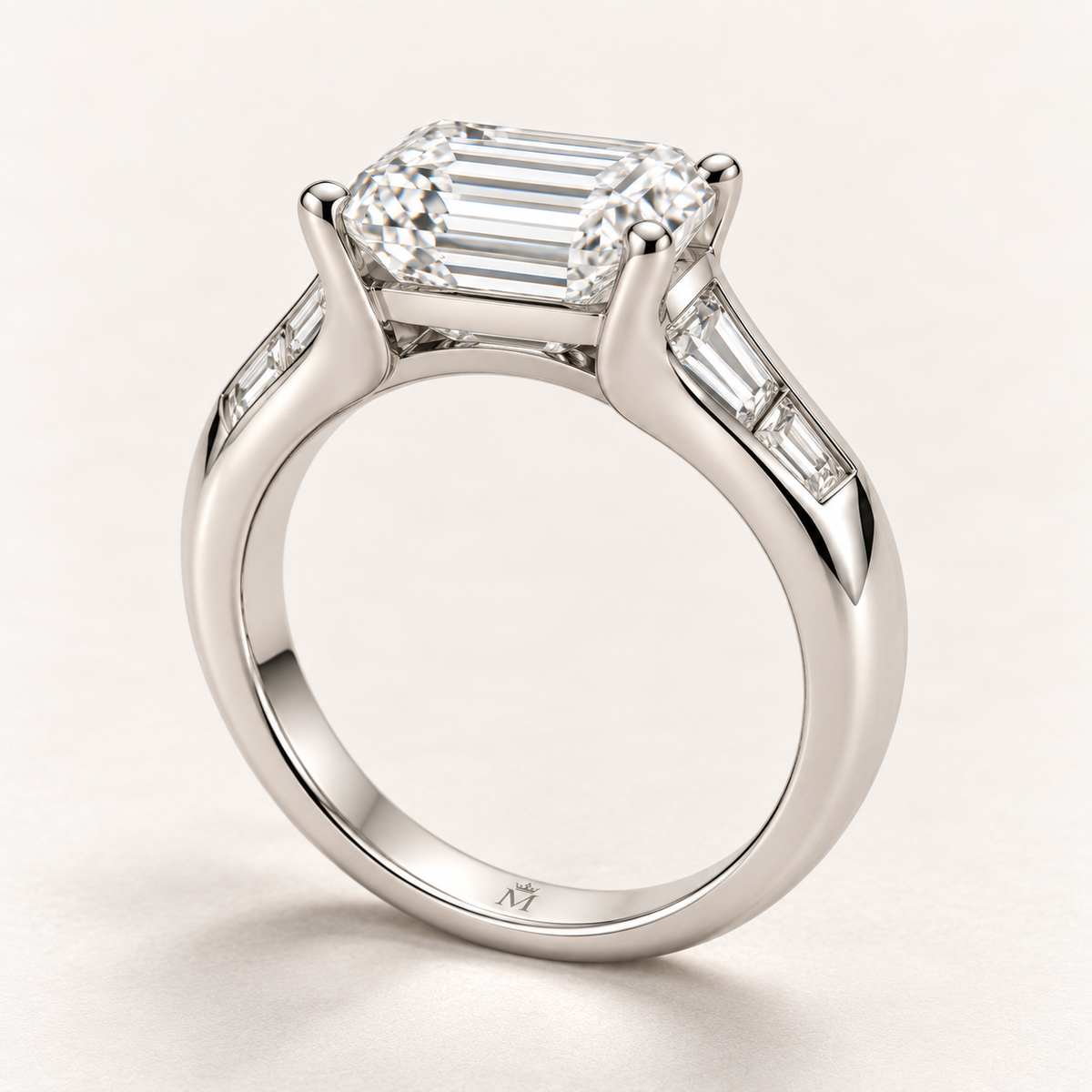 AI design preview of Soft Terrace emerald-cut ring in profile with solid shoulders and discreet inner crowned-M engraving