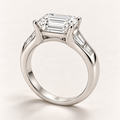 AI design preview of Soft Terrace emerald-cut ring in profile with solid shoulders and discreet inner crowned-M engraving