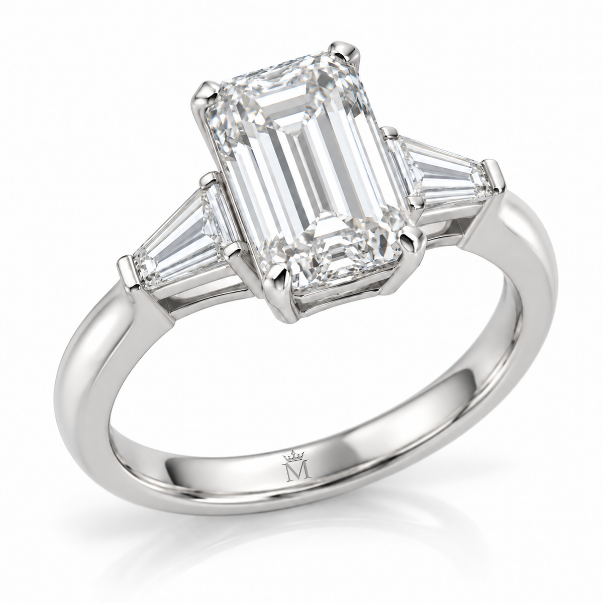 AI-generated design concept: Emerald cut ring, Prong-set center with two tapered baguette side stones, three-quarter view. Metal appearance is illustrative. Crown-M engraving design is shown inside the lower band; engraving is illustrative.