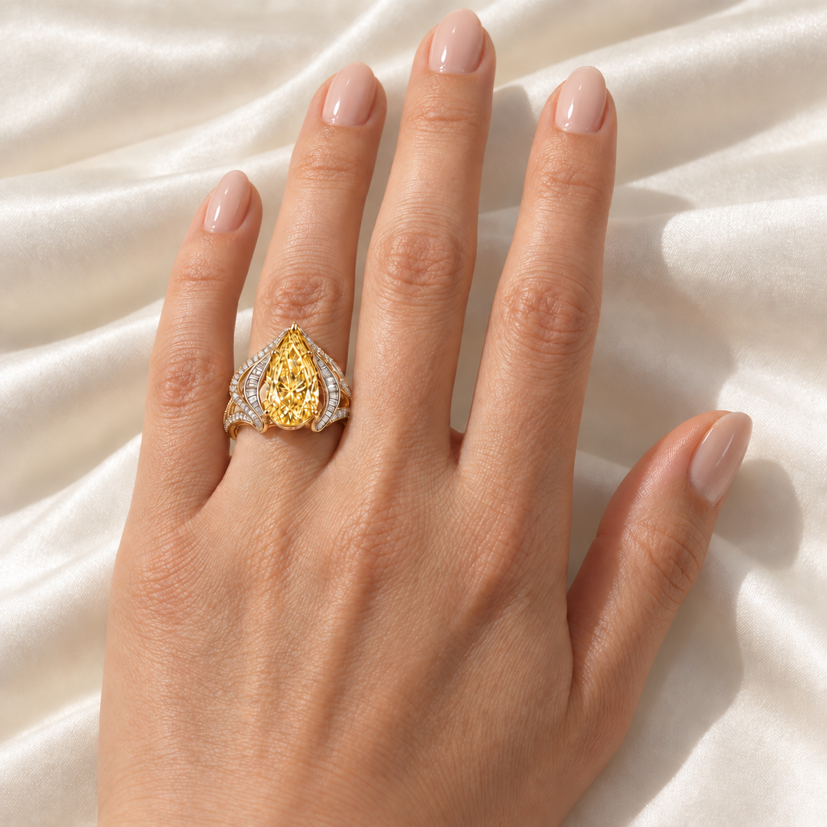 Solar Rhapsody yellow pear-shaped diamond ring on a left ring finger