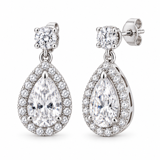 Cora pear halo drop earrings in 14K white gold, on a clean white background, front hero view.