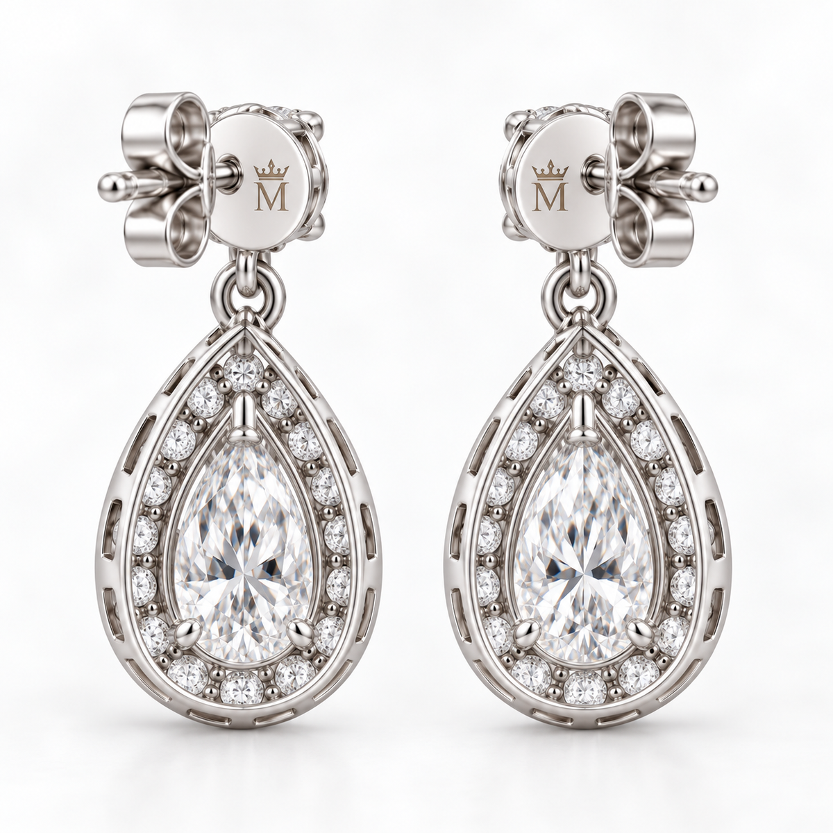 Cora pear halo drop earrings in 14K white gold, interior crowned-M hallmark detail.