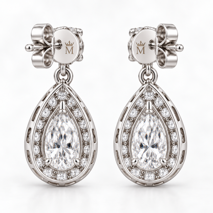 Cora pear halo drop earrings in 14K white gold, interior crowned-M hallmark detail.