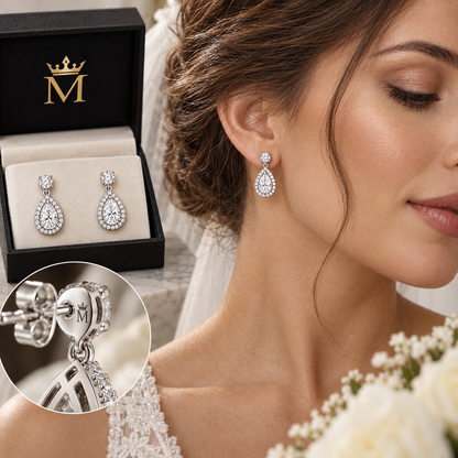 Cora pear halo drop earrings in 14K white gold, worn by a model.