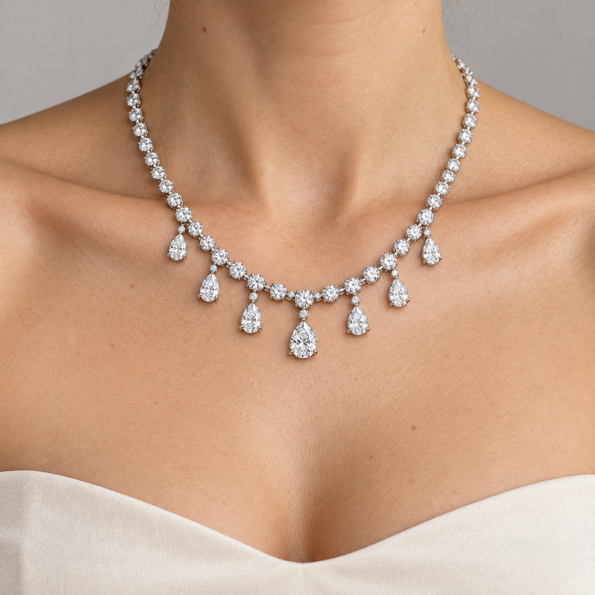 Adult model with light skin wearing the Dew Garland seven-pear-drop necklace
