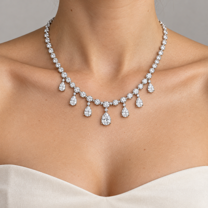 Adult model with light skin wearing the Dew Garland seven-pear-drop necklace