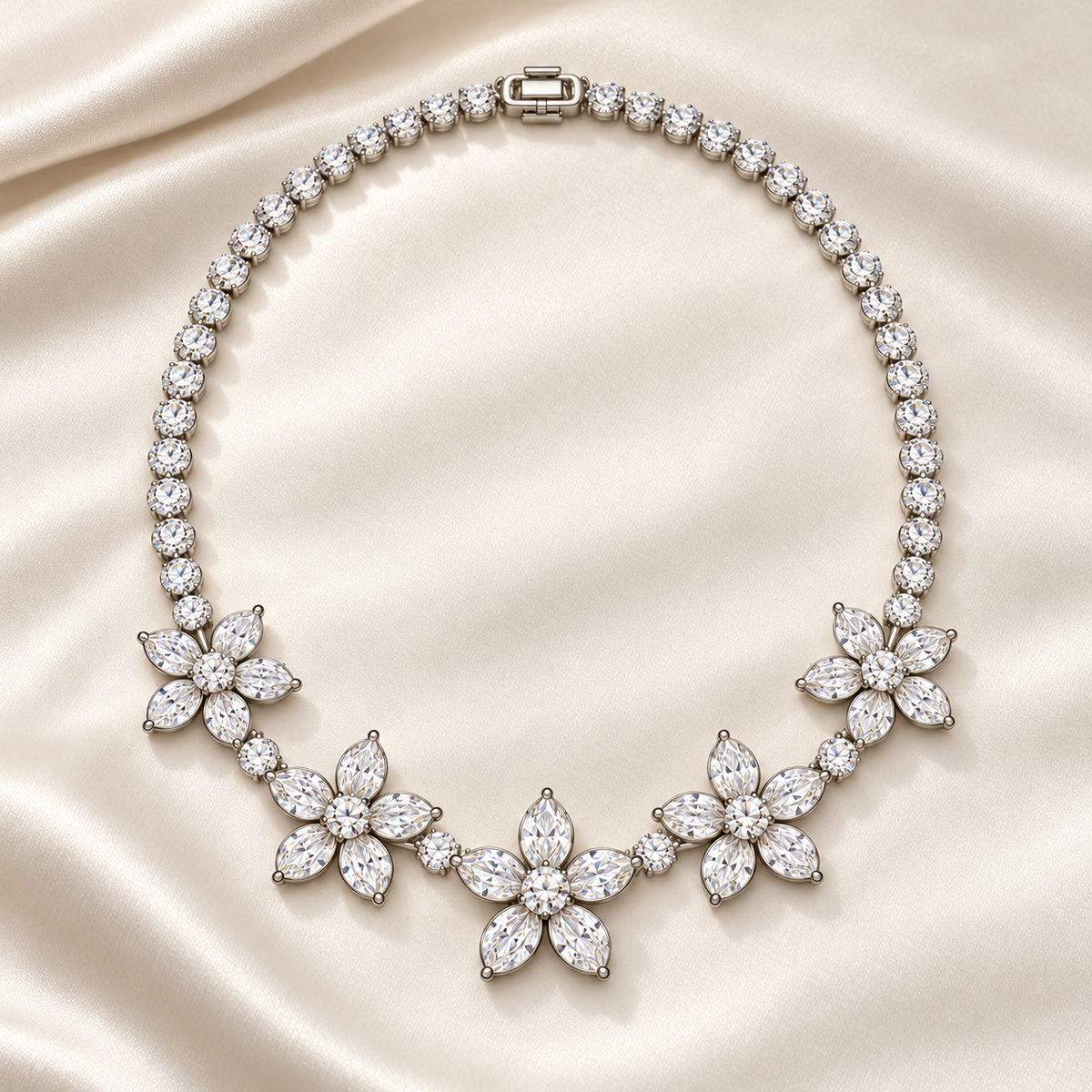 Five Petals necklace on pale satin, showing the five floral stations and complete necklace