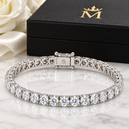 Evermore round diamond tennis bracelet in 14K white gold, interior crowned-M hallmark detail.