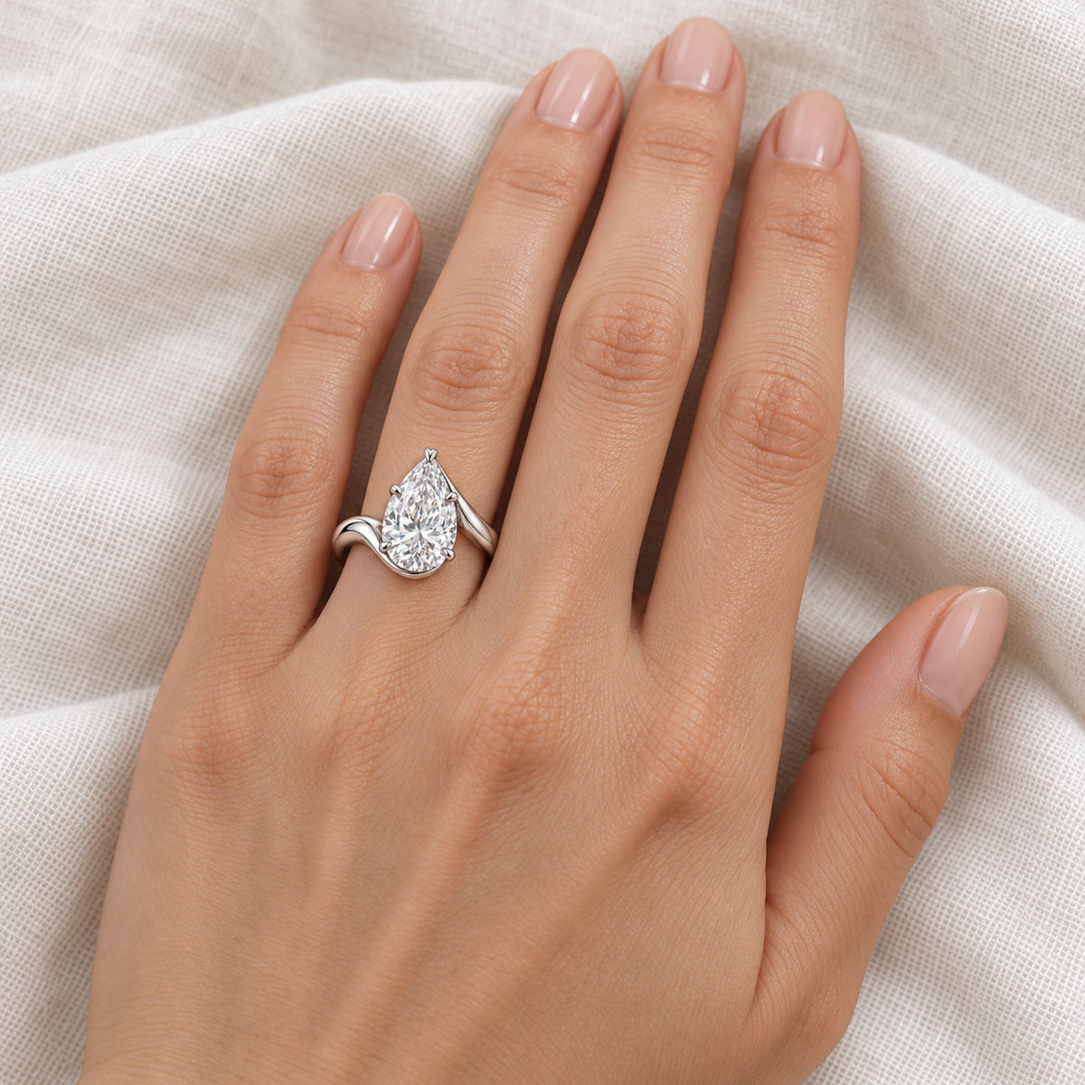 Willow Arc pear lab-grown diamond ring, adult left-hand wearing design visualization