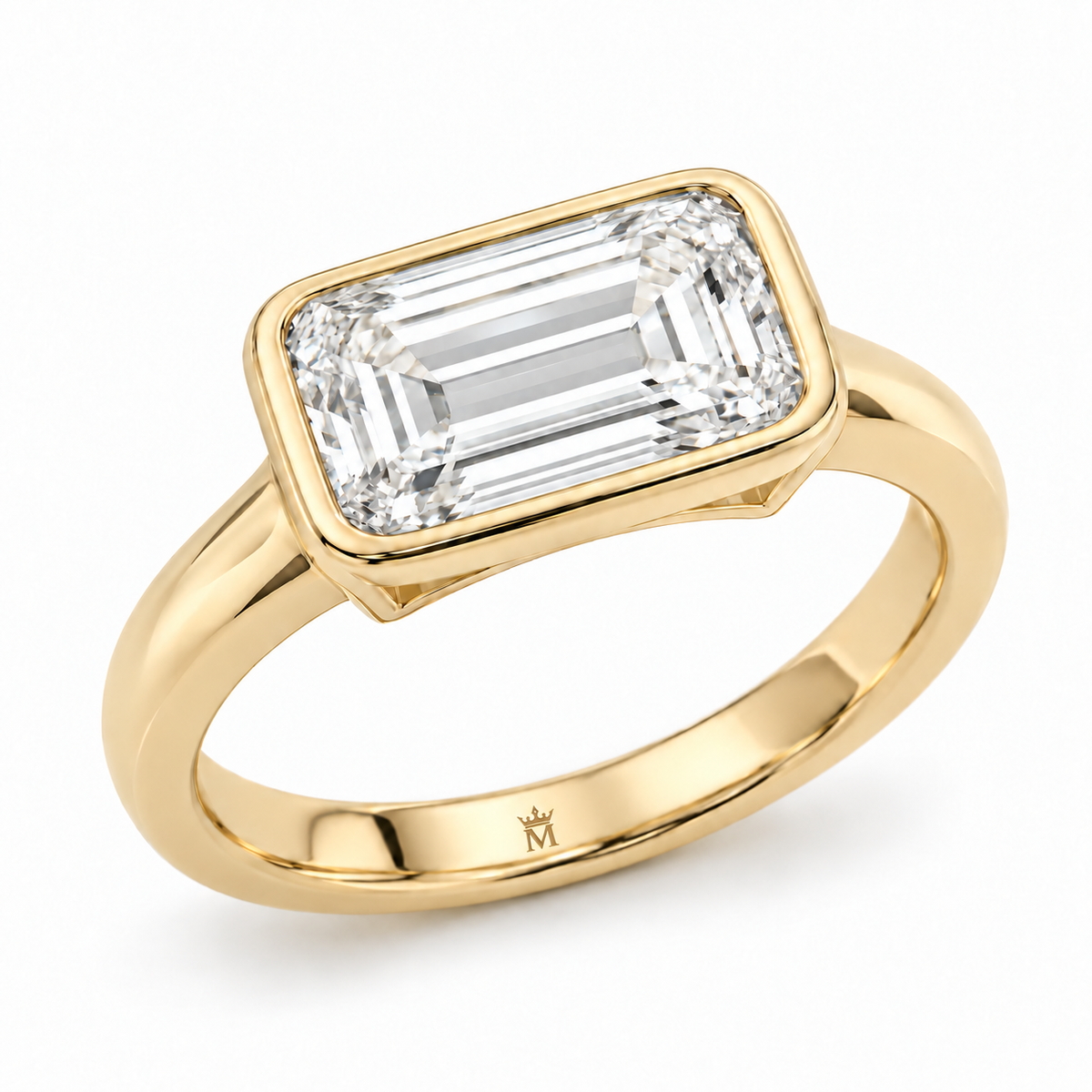A horizontally set 2.00 carat emerald-cut lab-grown diamond, framed by a slim full bezel with an open under-gallery and a polished tapered band. AI-edited crown-M engraving concept inside the lower band; engraving and scale are illustrative.