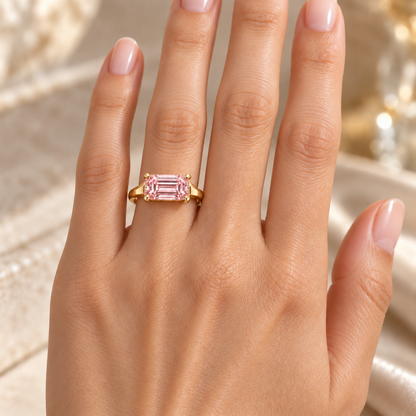 MISSISSI J02 pink emerald-cut ring worn on the ring finger of a left hand