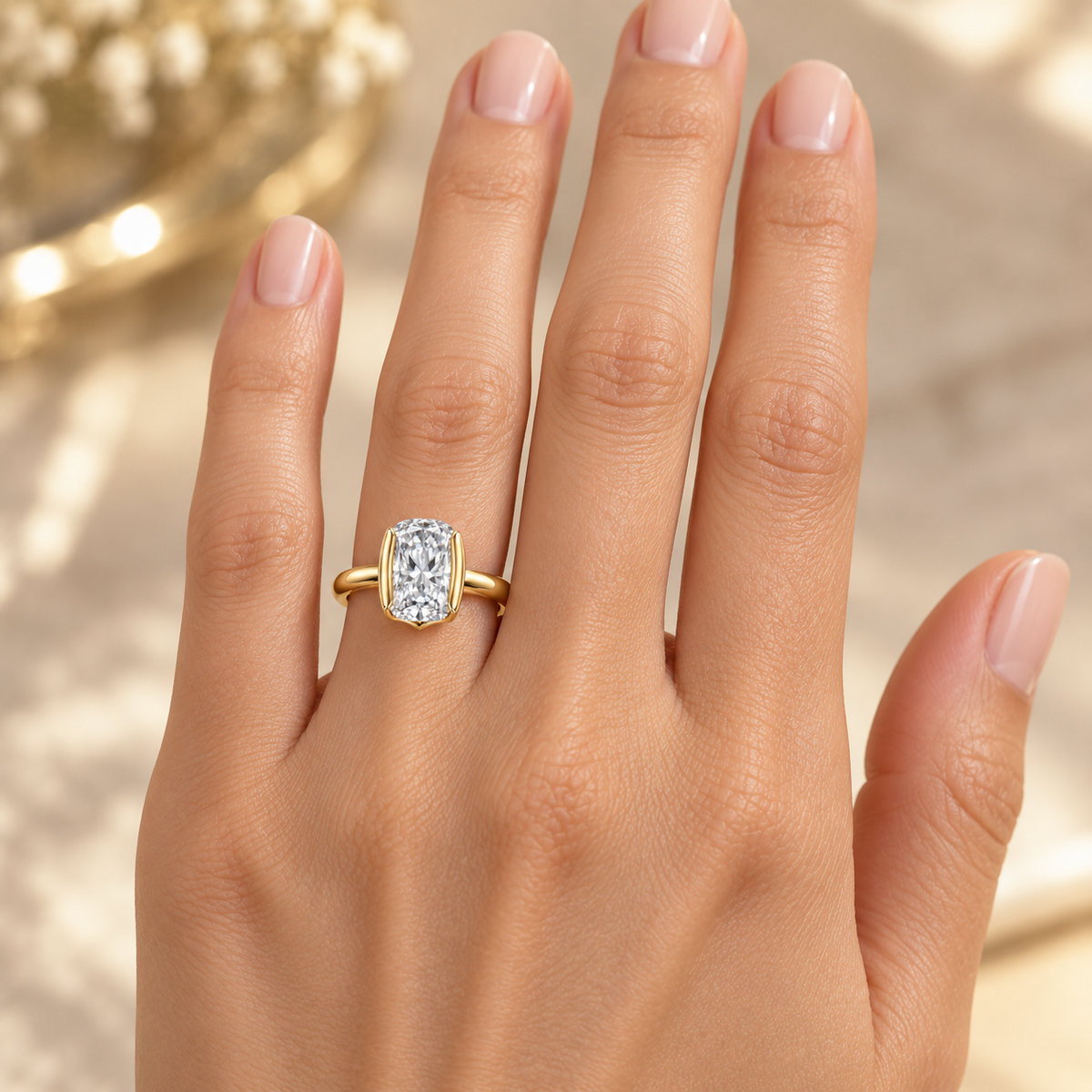 MISSISSI J04 colorless elongated cushion half-bezel ring worn on the ring finger of a left hand