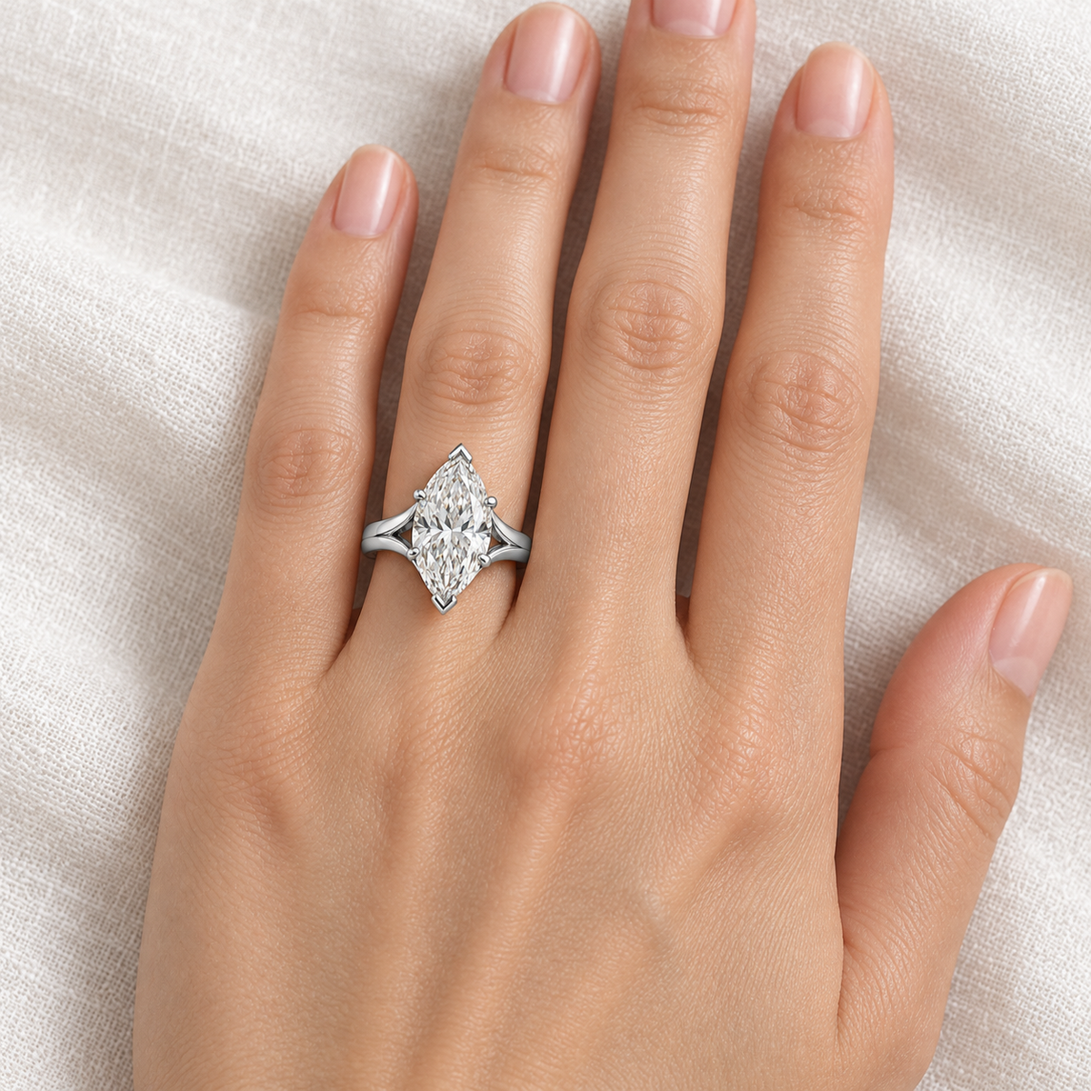 Silhouette marquise ring worn on an adult left ring finger; design visualization and illustrative scale