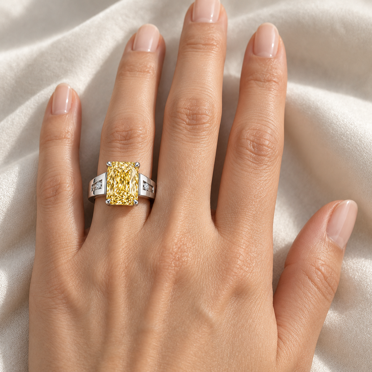 Solar Channel yellow radiant lab-grown diamond ring in white metal, worn on the left ring finger