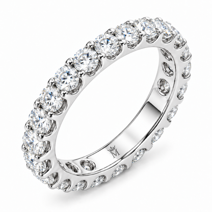 Lumen round diamond full-eternity wedding band in 14K white gold, interior crowned-M hallmark detail.