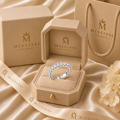 Lumen round diamond full-eternity wedding band in 14K white gold, presented in coordinated champagne-beige MISSISSI packaging.