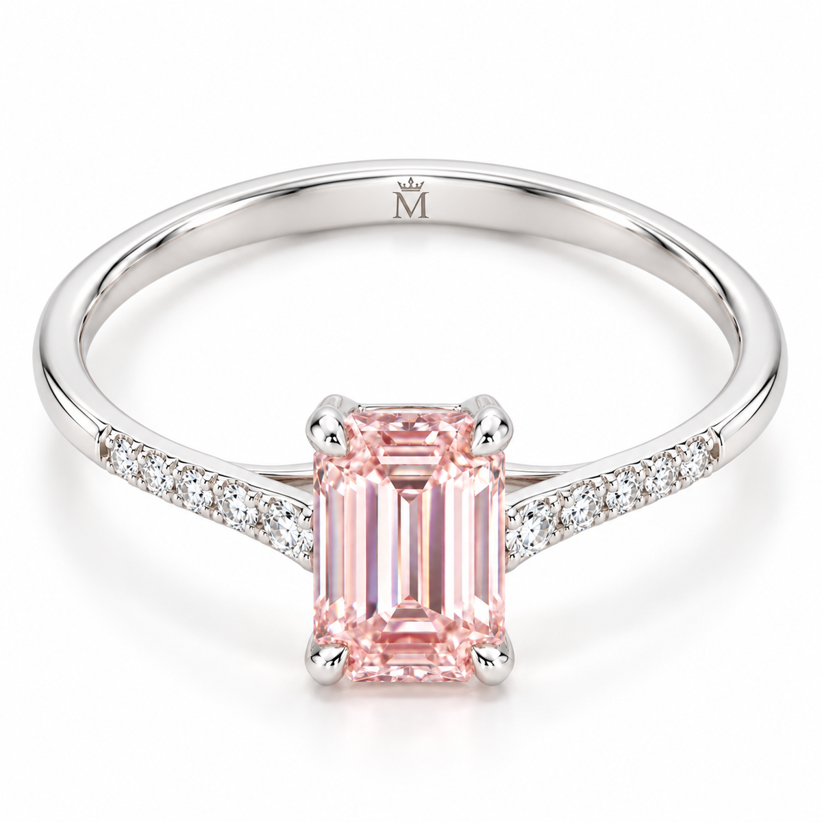 Tilted AI view showing the slender pink emerald-cut ring and a discreet crowned-M engraving inside the lower shank.