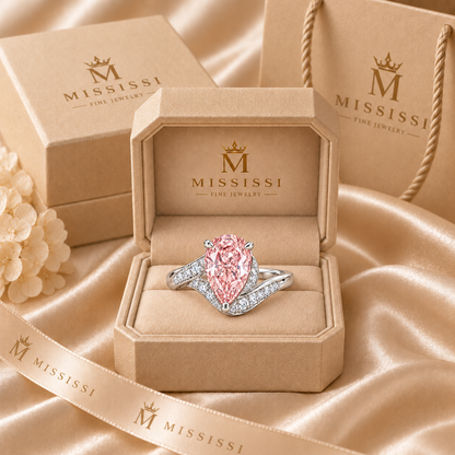 AI illustration of the pink pear bypass ring in champagne-beige MISSISSI packaging with matching carton, bag and ribbon.