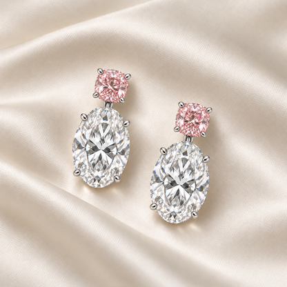 AI design illustration of the pink cushion and oval diamond earring pair resting face-up on ivory silk.
