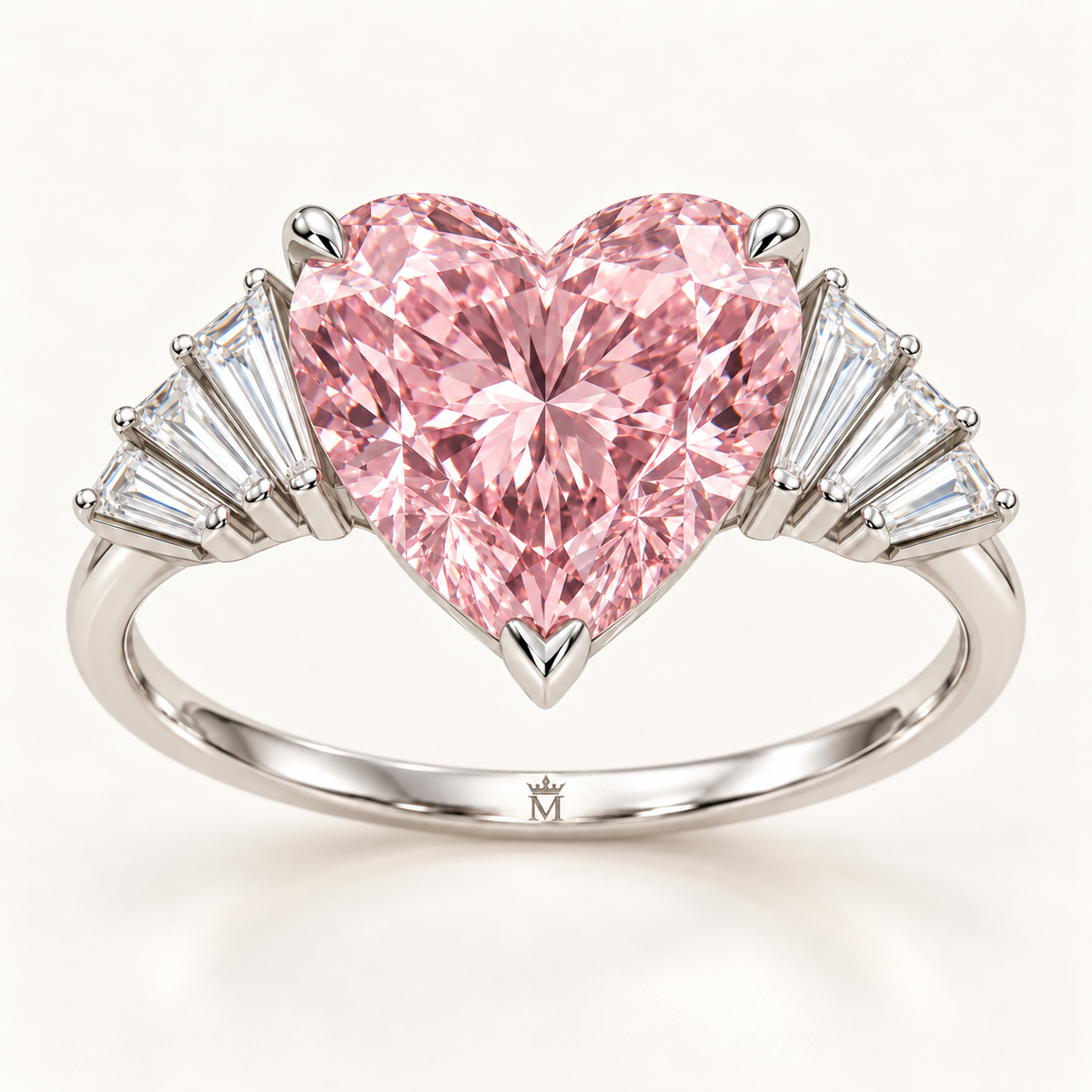 MISSISSI Pink Serenade ring with a pink heart-cut center and eight tapered baguette accents, front view with official crown-M inner-band engraving