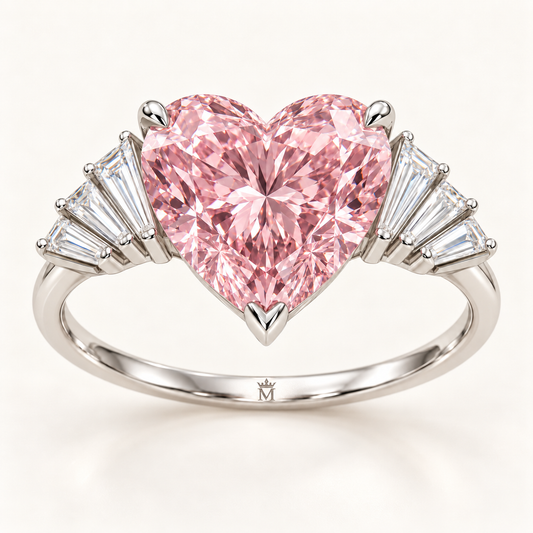 MISSISSI Pink Serenade ring with a pink heart-cut center and eight tapered baguette accents, front view with official crown-M inner-band engraving